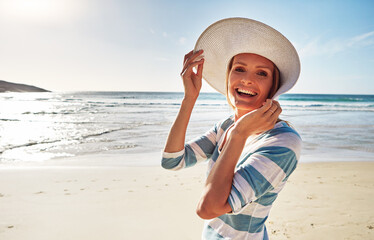 Wall Mural - Woman, portrait and happy at beach with hat for holiday, fun and break as tourist in Miami. Female person, coast and smile in summer vacation for adventure, travel and trip to relax and fresh air