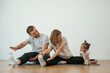 © standret - Family of mother, father and daughter are doing yoga at home