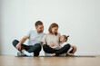 © standret - Family of mother, father and daughter are doing yoga at home