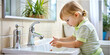 © Anelya - Close-up shot of a small child washing his hands