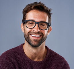 Fototapete - Portrait, happy and man in glasses on studio background for startup business with smart and intelligent face. Creative worker, entrepreneur or IT expert with smile for eye care, vision or confidence