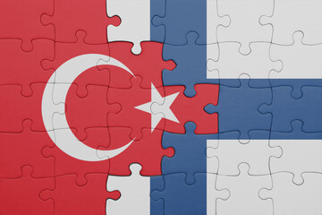 puzzle with the colourful national flag of finland and flag of turkey.