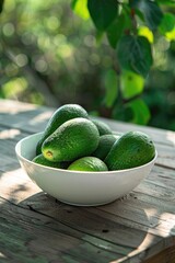 Wall Mural - avocado in a white bowl on a wooden table nature background. Selective focus
