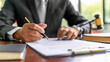 © Dina Photo Stories - Man businessman signs documents with a pen. Man reading and signing contract. Deal. Lawyer, executive manager filling out paper business document, signing contract, partnership agreement, Close up