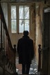 © Adobe Contributor - Man looking out the window in an abandoned house