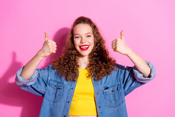 Photo of charming positive girl wear jeans shirt showing two thumbs up empty space isolated pink color background