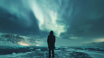 Canvas Print - a person stands on a frozen lake, looking out at the sky