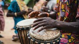 The image shows a close-up of a person playing a traditional African drum
