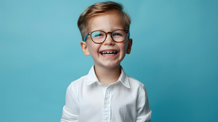 Wall Mural - Happy little boy wearing glasses and school uniform smiling on blue background. Copy space area for text