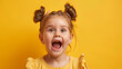 © standret - Portrait of happy excited kid with open mouth on yellow background