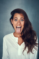 Sticker - Girl, portrait and tongue out for fashion in studio background for style, trendy and outfit in gray backdrop. Female person, gen z and excited expression in positive, cosmetic with pride or confident