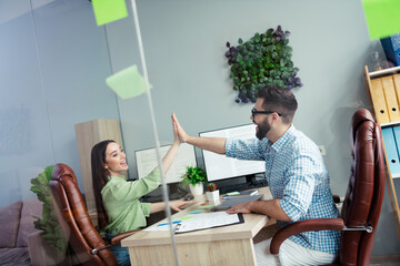 Canvas Print - Photo of happy smiling coworkers wear shirts giving arms palms high five indoors workplace workstation