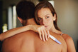© peopleimages.com - Woman, man and sad with hug for pregnancy test in bedroom, thinking and worry with anxiety in home. Couple, infertility and embrace for support, empathy and care for results in morning in apartment