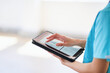 © Meeko Media - Medical Professional Using Tablet for Digital Health Records in Modern Hospital