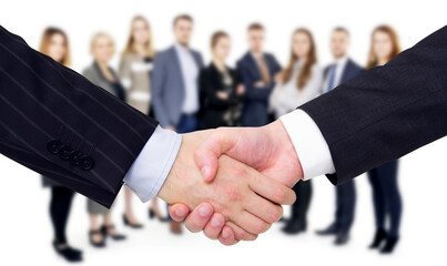 Aufkleber - Close-up of a handshake with a group of business people blurred in the background, symbolizing a business agreement. Generative AI