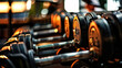© COK House - A rack of dumbbells in a gym. The focus is on the closest set of dumbbells, which are black with silver handles and have visible weight markings.