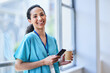 © Meeko Media - Smiling Nurse Taking a Break with Coffee and Smartphone in Hospital