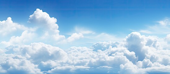 Poster - White clouds fill the sky with a backdrop of blue, creating a peaceful and serene atmosphere for any copy space image.