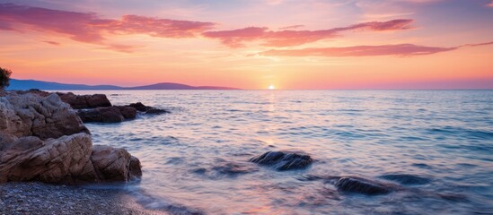 Poster - Sunset over the sea with a tranquil tide and a beautiful view in the background with copy space image.