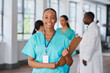 © Meeko Media - Smiling Medical Professional Holding Clipboard in Multi-Ethnic Hospital Setting