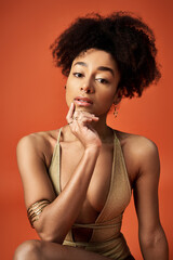 Poster - African American woman in gold swimsuit strikes pose with hand on chin.