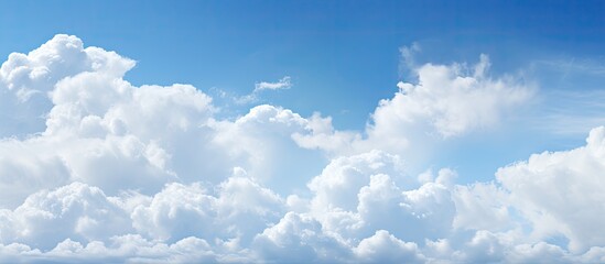 Aufkleber - A picturesque scene showing a clear blue sky with fluffy white clouds, providing a serene copy space image.