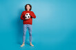 © deagreez - Full length photo of cheerful positive guy dressed red pullover enjoying football game emtpy space isolated blue color background