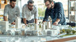 © Studio Zenith - Maquette d'un quartier, équipe de promoteurs immobiliers, d'architectes et d'hommes d'affaires travaillant sur un projet d'urbanisme