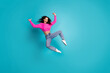 © deagreez - Full body photo of attractive teen girl jump have fun excited dressed stylish pink clothes isolated on aquamarine color background
