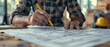© Media Srock - Architect sketching project blueprint at construction site or office desk