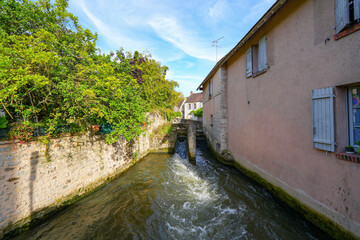 Sticker - River La Cléry flowing at the foot of the houses of Ferrière-en-Gâtinais in the French department of Loiret, Centre Val de Loire, France