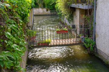 Sticker - River La Cléry flowing at the foot of the houses of Ferrière-en-Gâtinais in the French department of Loiret, Centre Val de Loire, France