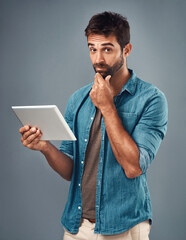 Poster - Tablet, smile and studio with man thinking, portrait and social media on gray background. Internet, online and communication for texting on dating app, chat and male person on technology for love
