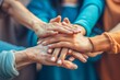 © Odin AI - Close-up of diverse group of people's hands together, symbolizing teamwork, unity, and collaboration