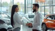 © MP Studio - The handshake in car dealership