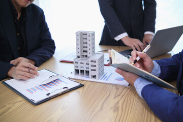 group of businessmen and investors discuss investing in real estate and jointly plan investments in construction projects of condominiums and apartments for sale and rent. investment advisory concept