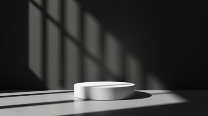 Leinwandbilder - A white circular object sits on a surface in a dimly lit room with sunlight streaming through geometric shadows.