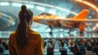 © Thanaphon - Woman in aerospace uniform observing advanced jet inside a futuristic hangar with audience, showcasing innovation in aviation technology.