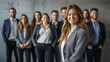 © Michael - Smiling businesswoman leading a team of professionals in a corporate setting