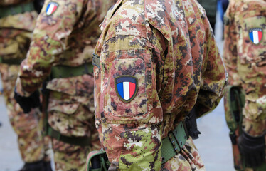 military soldier in camouflage uniform with the flag of FRANCE with the three colors