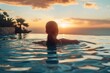 © Odin AI - The serene image of a woman swimming in an infinity pool as the sun sets, evoking peace and relaxation