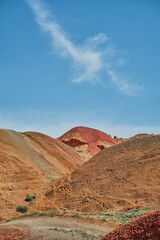 Vertical postcard with view of red mountains under bright blue spring sky, picturesque and serene alien landscape with copy space for concept