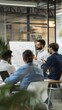 © alphaspirit - Group of professionals engaged in a strategic meeting with one presenting on whiteboard