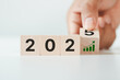 © THAWEERAT - Flipping wooden cubes to 2025 and growth performance. 2025 business growth, acceleration concept. New year business goals, plan, strategy. Banner for the new action plan ,annual plan, growth, target.