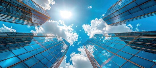 Wall Mural - In the center of an office building complex, there is a sky with blue glass buildings and white clouds.