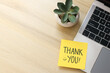 © Queenmoonlite Studio - Top View Of Yellow Sticky Note Written Thank You on Laptop With Succulent Over Wooden Background