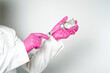 © Aria Armoko - doctor or scientist holding a syringe with ampules vaccine, bottle for injection