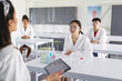 © Wavebreak Media - Teenage Asian girl and classmates listen in school lab, copy space