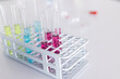 © Wavebreak Media - Test tubes filled with colorful liquids in a lab rack, with copy space