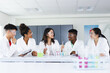 © Wavebreak Media - Diverse students engage in a science experiment at high school